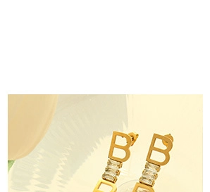 Detailed close-up of 18K gold-plated heart earrings featuring B letter and zircon stones