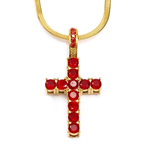 Detail of gold snake chain with a cross pendant featuring vibrant red zircon stones