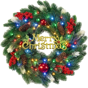 Christmas wreath with LED lights, red berries, pine cones and gold Merry Christmas sign