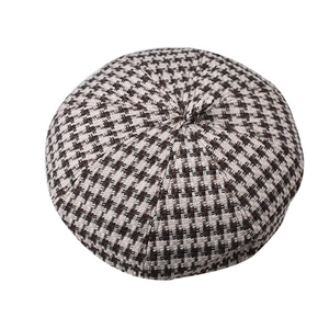 Top view detail of houndstooth wool beret showing premium woven texture and pattern