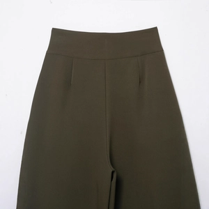 Olive green high waist pleated trousers with wide waistband and relaxed balloon fit