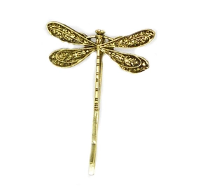 Macro view of vintage dragonfly hair clip showing intricate wing details in antique gold