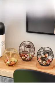 Three metal wire coffee pod baskets in gold, bronze, and black with hollow COFFEE lettering