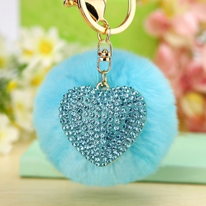 Blue faux fur pompom keychain with a rhinestone studded heart charm and metal ring