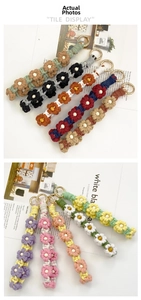 Macro shot of colorful hand-woven daisy keychains with wooden beads and gold clasps