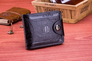 Close-up of black leather wallet with 100 dollar bill embossing and metal snap button