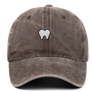 Detailed embroidery of white teeth on a vintage washed brown cotton baseball cap