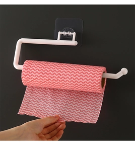 Wall-mounted white paper towel holder detail with red striped cleaning cloth on black wall