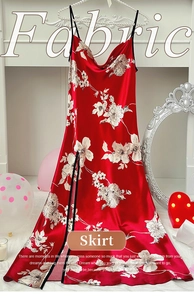 Detail of red silk slip nightgown with white floral print and black trim side slit