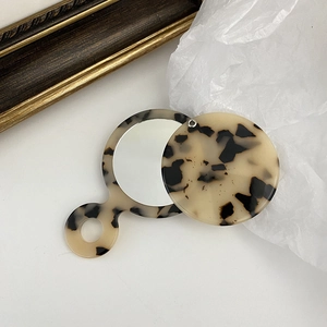 Portable round acetate makeup mirror with tortoiseshell pattern and sliding cover design