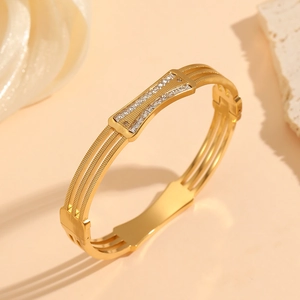 Detailed close-up of a gold-plated titanium steel bracelet with three-layer zircon crystals