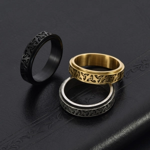 Detailed macro of vintage Celtic knot spinner rings in gold black and silver steel