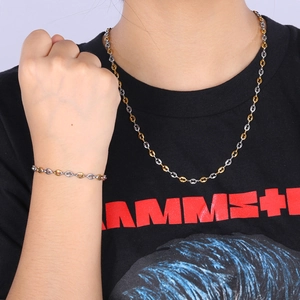 Two-tone silver and gold coffee bean link necklace and bracelet set on model