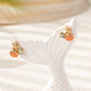 Asymmetric starfish and shell stud earrings with iridescent rhinestones in gold
