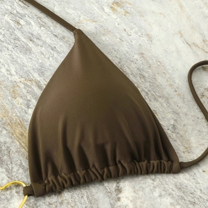 Detailed view of chocolate brown triangle bikini top with gold ring and ruching