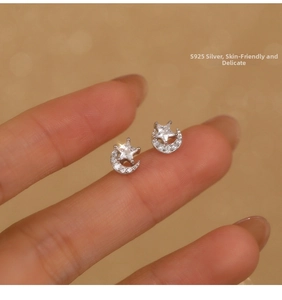 Close-up of S925 sterling silver moon and star earrings with sparkling zircon stones