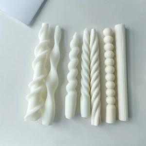 Set of 6 white pillar candles with spiral, spherical, and striped textured wax designs