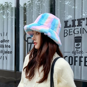 Close-up of a colorful rainbow fuzzy bucket hat featuring soft plush striped texture