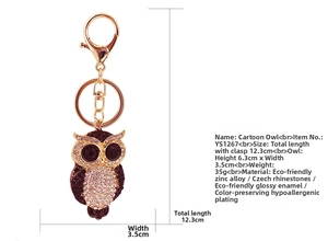 Macro detail of jeweled owl keychain with Czech rhinestones and red enamel finish
