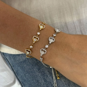 Adjustable stainless steel heart bracelet with shell and cubic zirconia on wrist