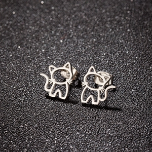 Macro shot of polished silver hollow cat stud earrings with secure butterfly backs
