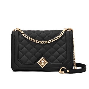 Classic black quilted crossbody bag with golden chain strap and diamond lock on white base