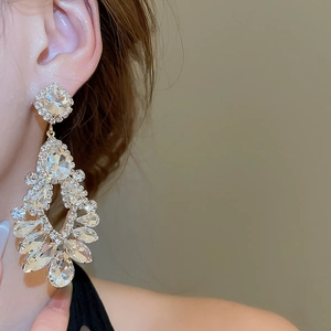 Detail of silver drop tassel earrings with sparkling crystals for elegant bridal jewelry