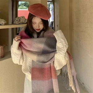 Close-up of rainbow plaid mohair scarf with fringe details and pink beret hat
