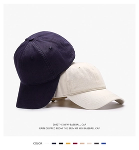 Detail of navy and beige cotton twill baseball caps with various color swatches