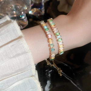 Macro detail of luxury candy-colored zircon bracelet with gold-plated metal setting