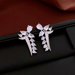 Detailed view of silver drop earrings with sparkling zircon crystals in leaf design