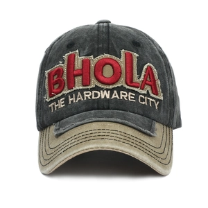 Detail of 3D BHOLA embroidery on a vintage washed grey and khaki baseball cap