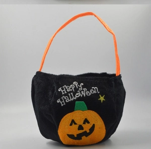 Macro detail of black velvet Halloween candy bag with orange pumpkin and star embroidery