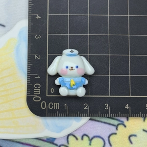 Macro shot of a cartoon dog figurine in sailor suit on a measuring mat for size reference