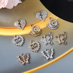 DIY jewelry making pendants in heart, butterfly, and snail shapes with rhinestones