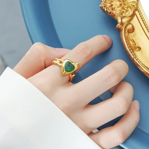Elegant gold-plated titanium steel ring featuring a heart-shaped green stone and chain band