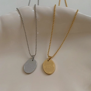 Minimalist stainless steel oval Good Luck pendant necklaces in gold and silver finishes