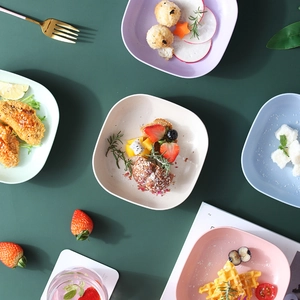 Set of luxury square fruit plates in various colors with golden edges and Nordic style texture