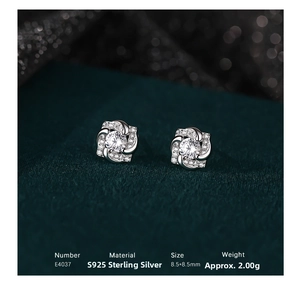 Macro shot of S925 sterling silver four-petal floral stud earrings with cubic zirconia