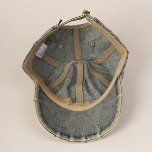 Internal view of washed denim baseball cap showing sweatband and adjustable metal buckle