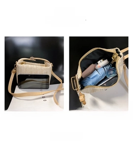 Detail view of beige straw woven crossbody bag showing large internal capacity for daily items