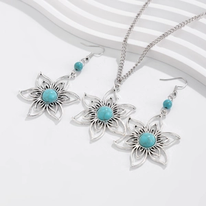 Detail of silver bohemian jewelry set with turquoise heart and palm tree design