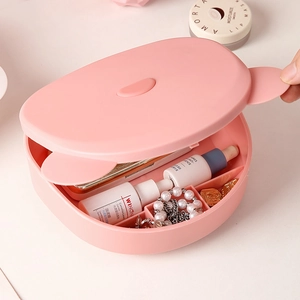 Pink folding makeup mirror and desktop storage box with internal compartments for cosmetics