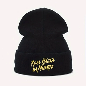 Close-up of black beanie with high-quality yellow REAL HASTA LA MUERTE embroidery detail
