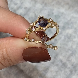 Elegant gold vine ring with pear-cut purple zircon and white crystal accents