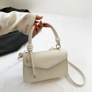 Minimalist white textured leather crossbody square bag with a woven handle and gold hardware