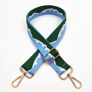 Adjustable woven replacement bag strap with green mountain jacquard and gold metal hooks