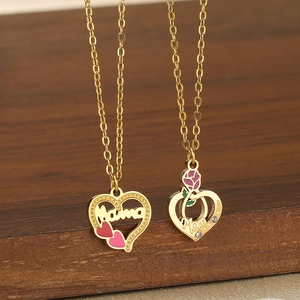 Detail of 18K gold-plated Mama and Mom heart necklaces with rose and crystal accents
