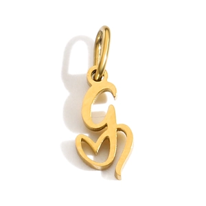 Detailed close-up of a golden G-letter pendant with a polished metallic finish