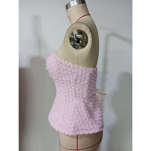 Detail of pink crop top featuring textured 3D rose petals and strapless design
